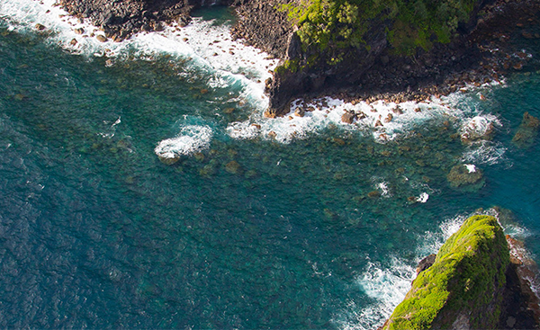 Aerial view of a rocky coastline with turquoise waters.