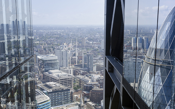 Landscape of London taken from the City, with the Gherkin building reflected.