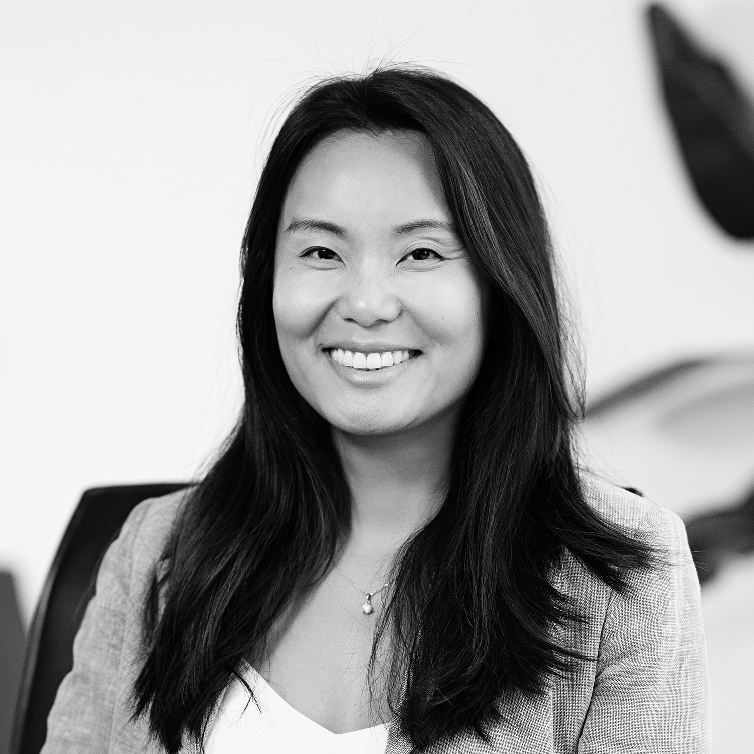 Black and white formal headshot of Daisy Huang.